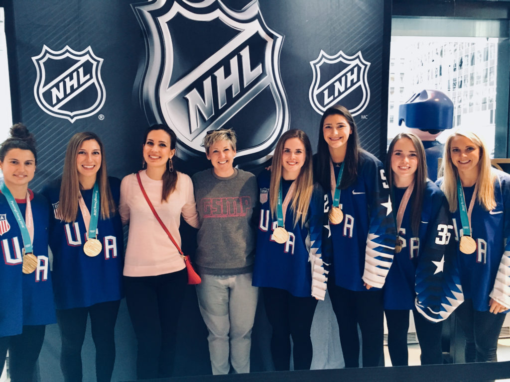 CSPS director Dr. Sarah Hillyer with the U.S. Olympic Women's Hockey team and GSMP alumna Olga Dolinina